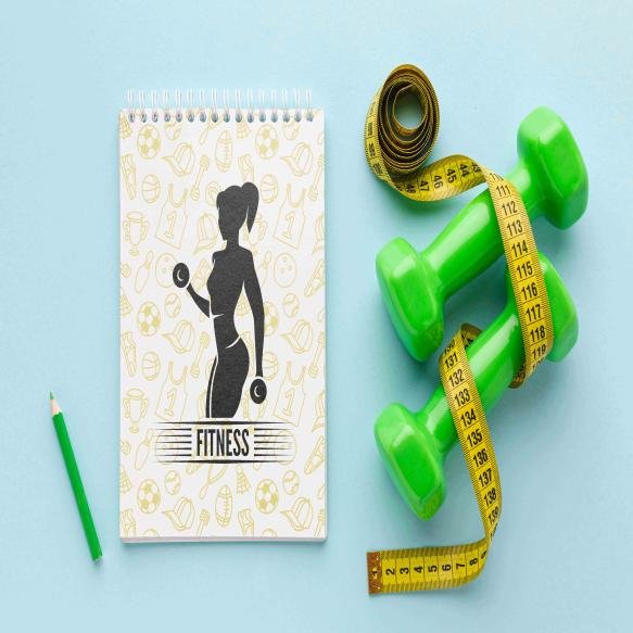 Notebook Beside Fitness Equipment