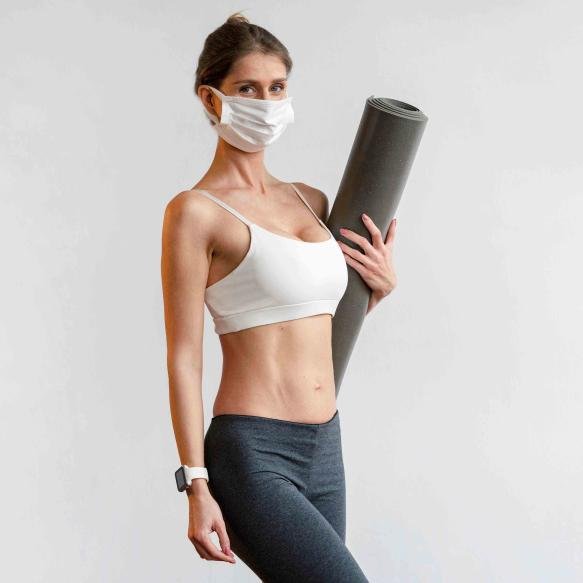Woman With Face Mask Holding Yoga Mat